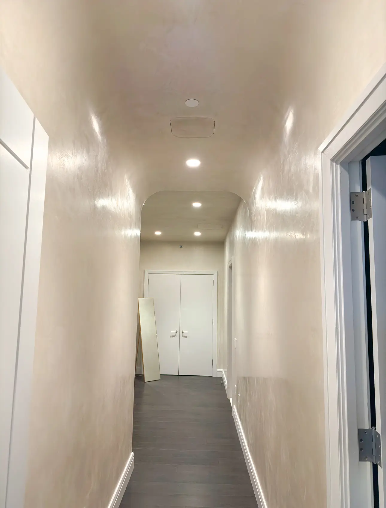 Laight St Residence — plaster corridor leading toward the bedroom suite