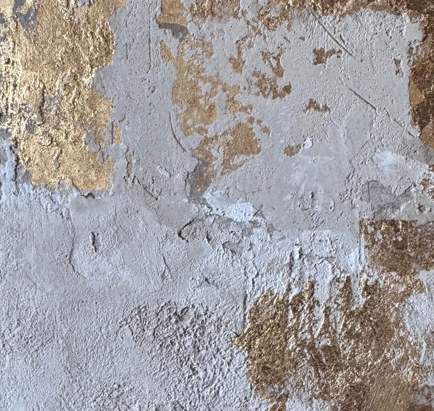 Gold leaf over hand-troweled lime plaster
