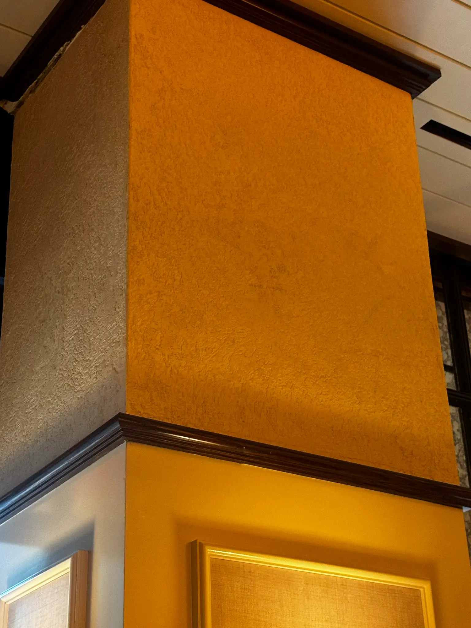 Carversteak NYC — detail of venetian plaster wrapping a column corner in mustard gold