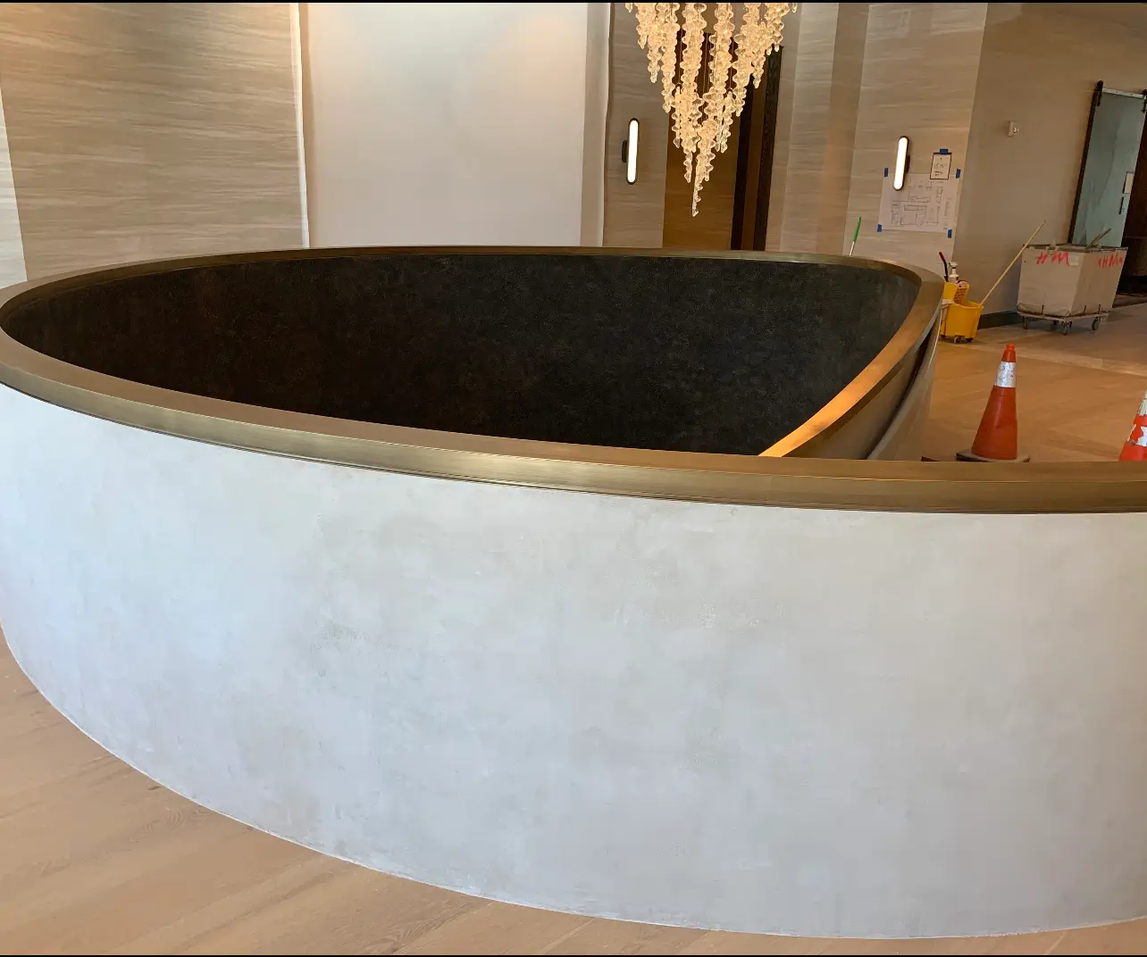 St. Regis Residences Rye — stair enclosure showing the plaster finish meeting the bronze rail