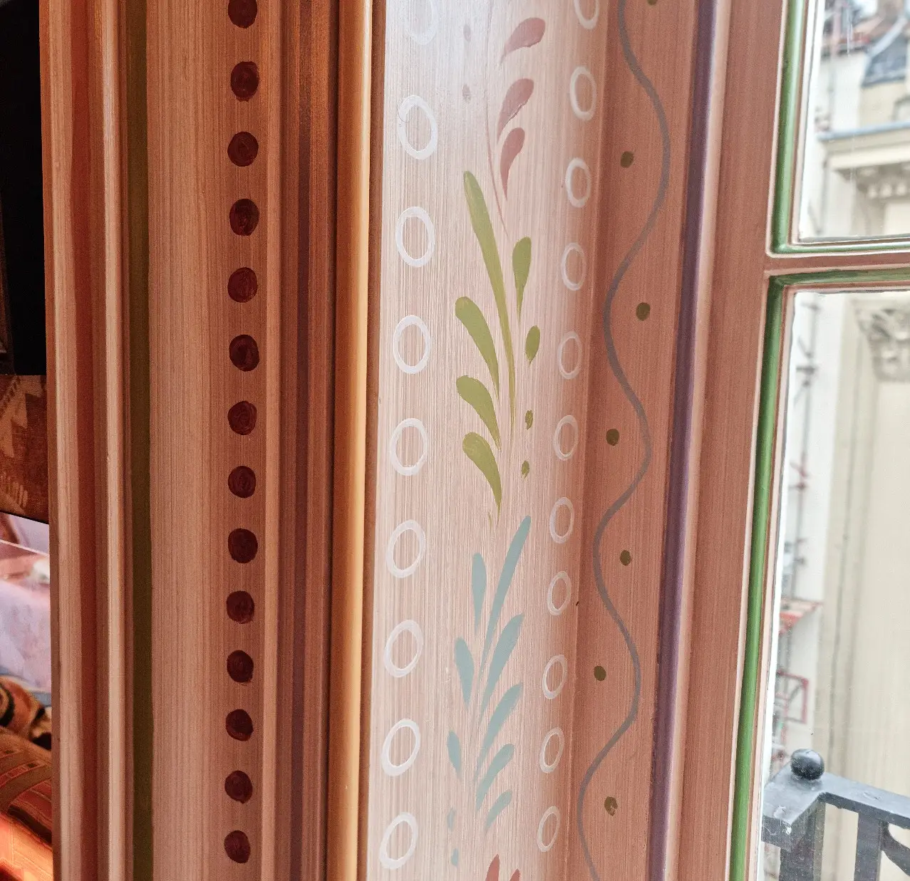 Maxime's — hand-painted trim wrapping a window frame